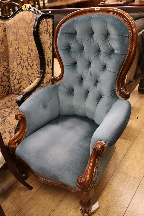 A blue button upholstered spoon back armchair